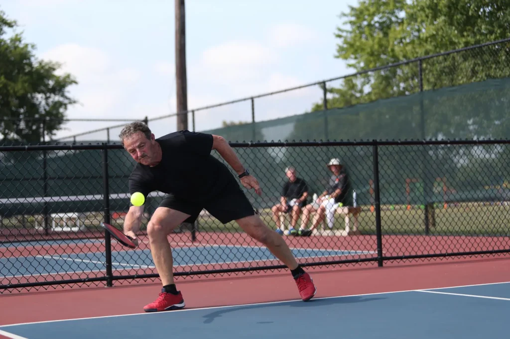 A senior competes in the singles division of a pickleball tournament
