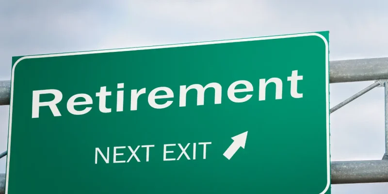 "Retirement, Next Exit" on a green highway sign