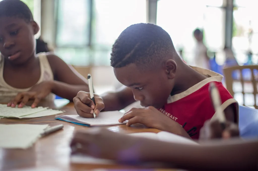 student writing in a classroom
