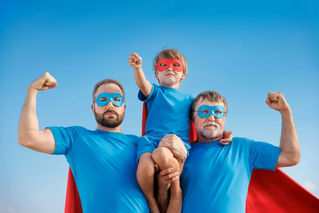 Senior, man and child outdoor against summer blue sky. Grandfather, father and son pretend to be superheroes. People having fun together. 