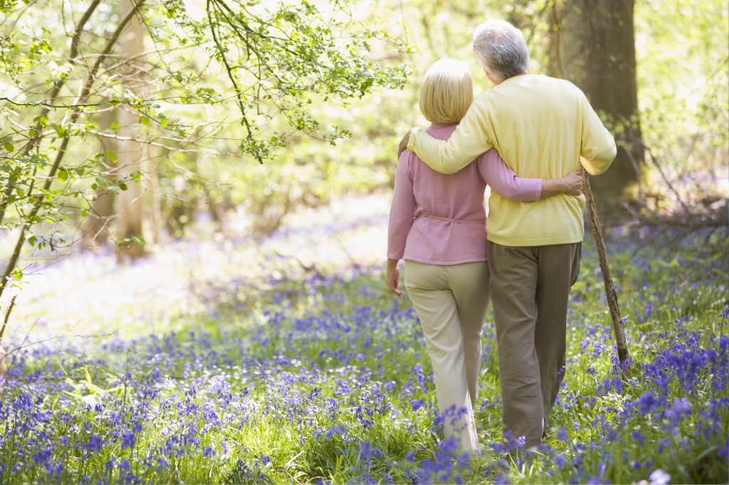 senior couple walking through wildflowers