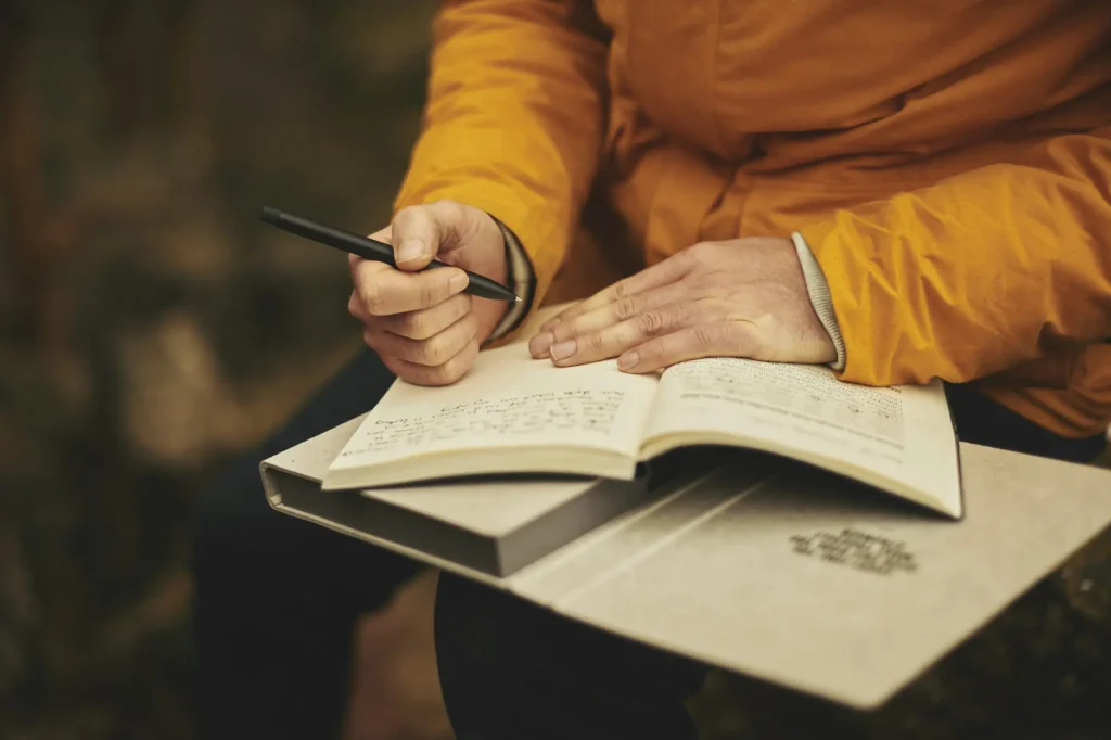 older adult writing in journal