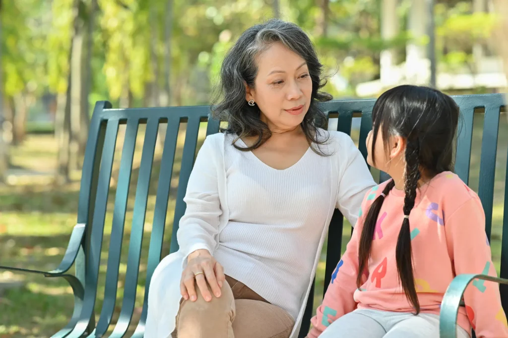 grandma with little girl on bench