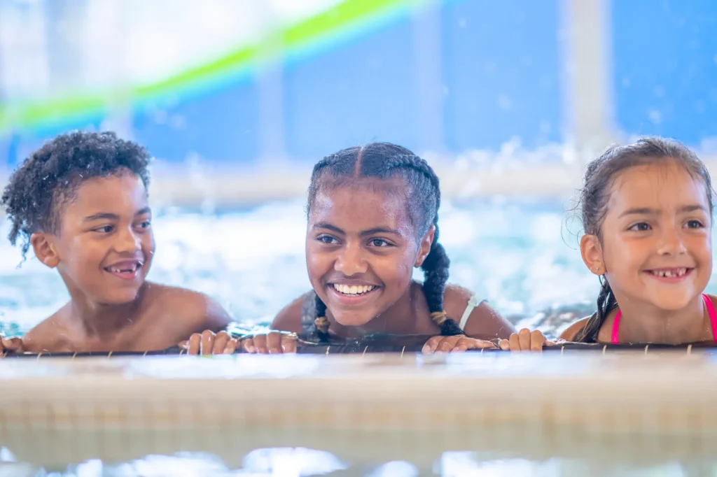 happy kids swimming in pool