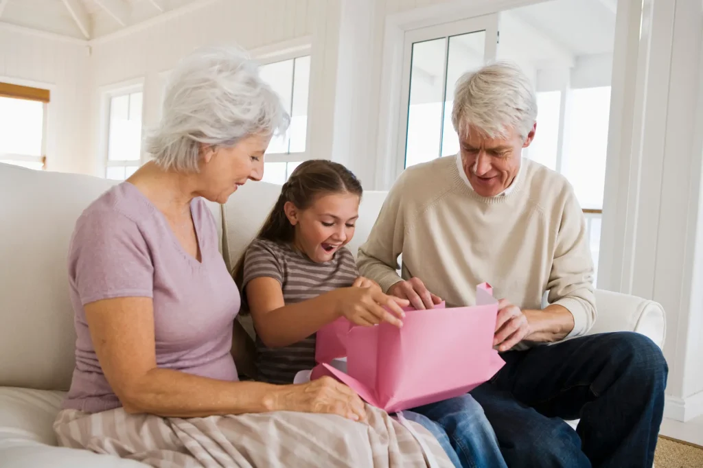 grandparents with granddaughter, gift