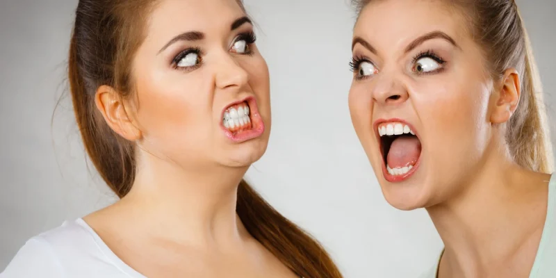 Two agressive women having argue fight being mad at each other.