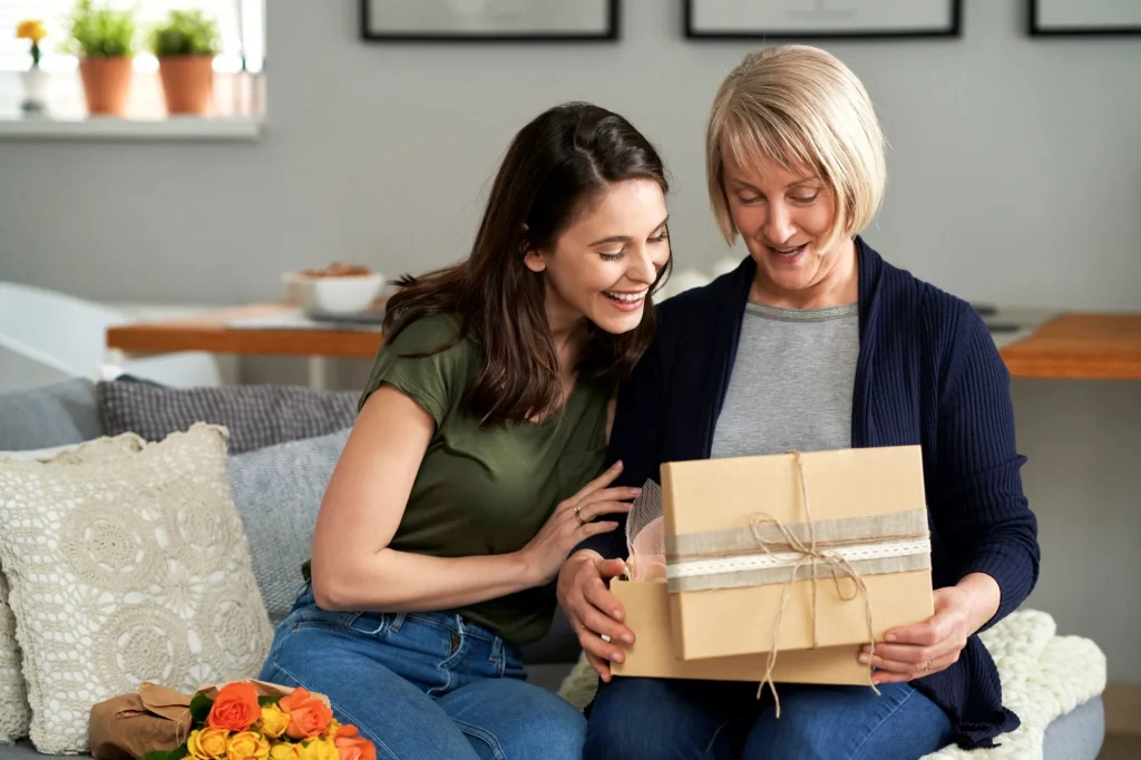 adult daughter giving boomer mom present