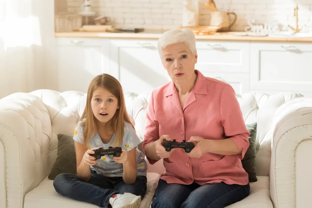 grandma and granddaughter playing video games together