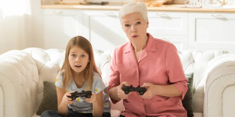 grandma and granddaughter playing video games together