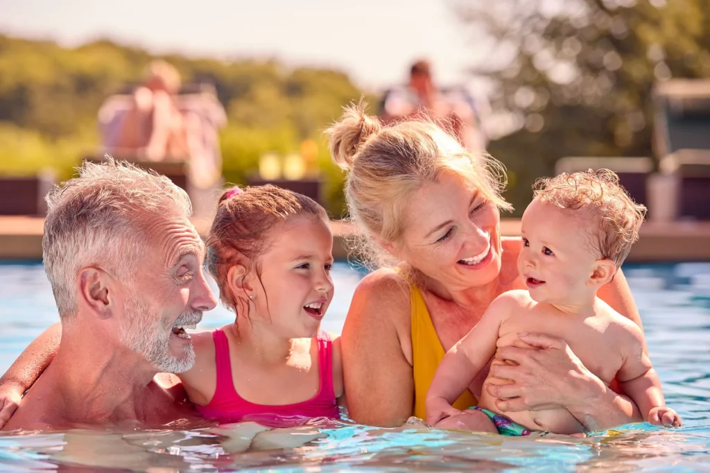 grandparents in pool with grandkids