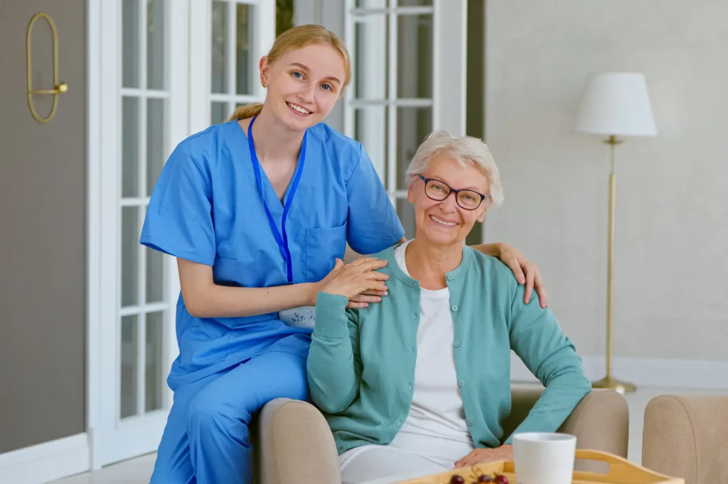 nurse and older woman smiling at camera