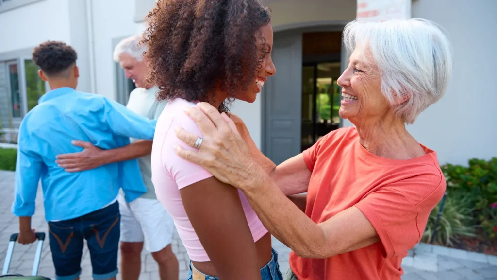 Grandparents Greeting Family With Teenage Children Coming To Visit