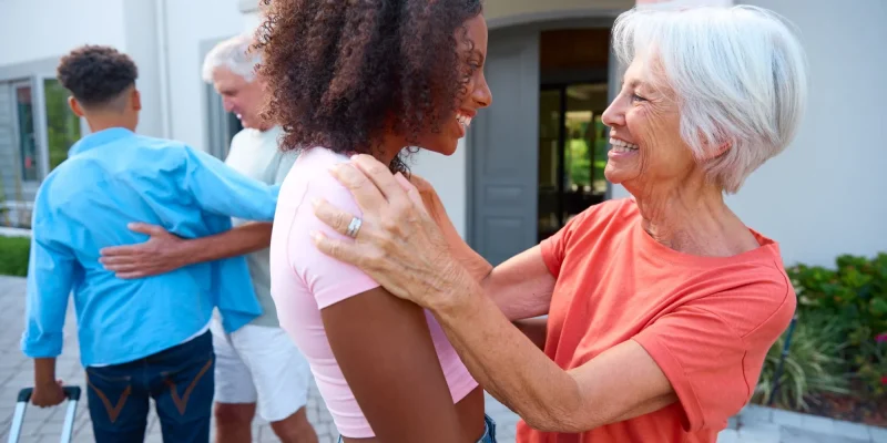 Grandparents Greeting Family With Teenage Children Coming To Visit