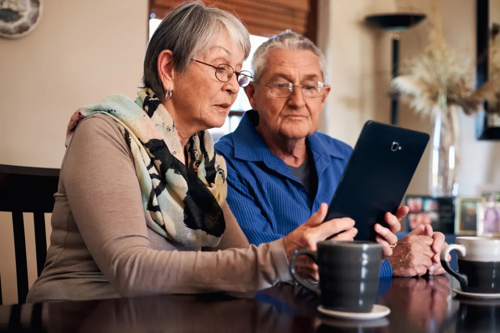 senior couple looking at tablet