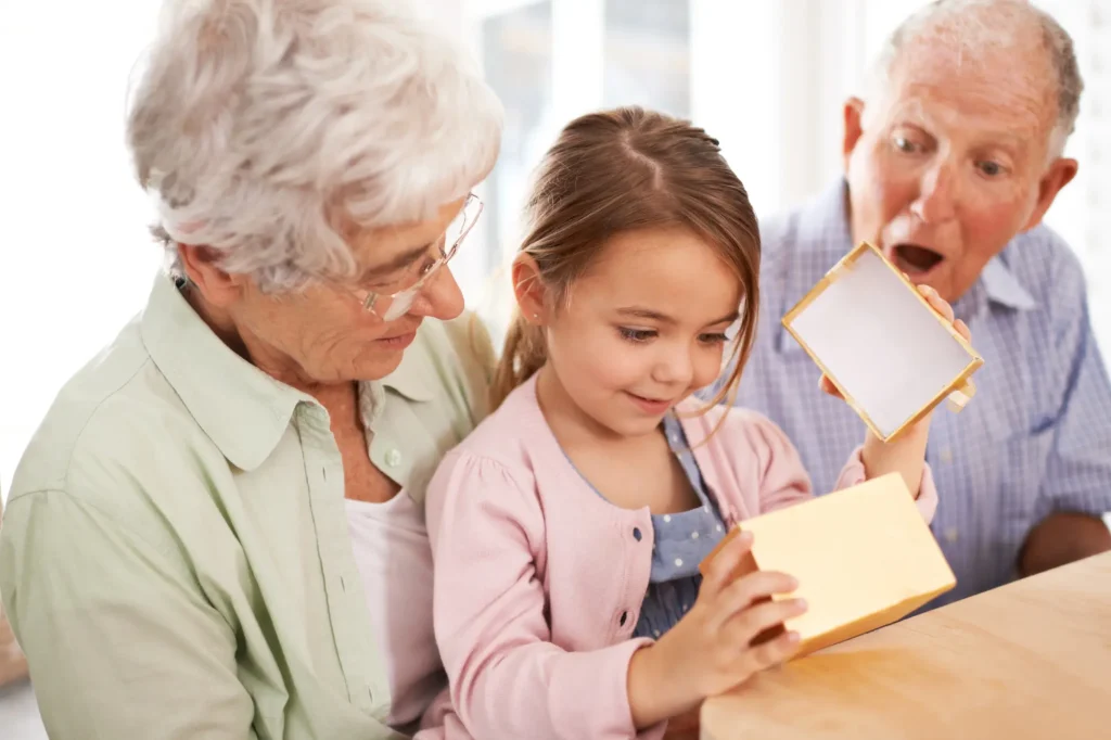 gift box and grandkid getting birthday present from grandparents