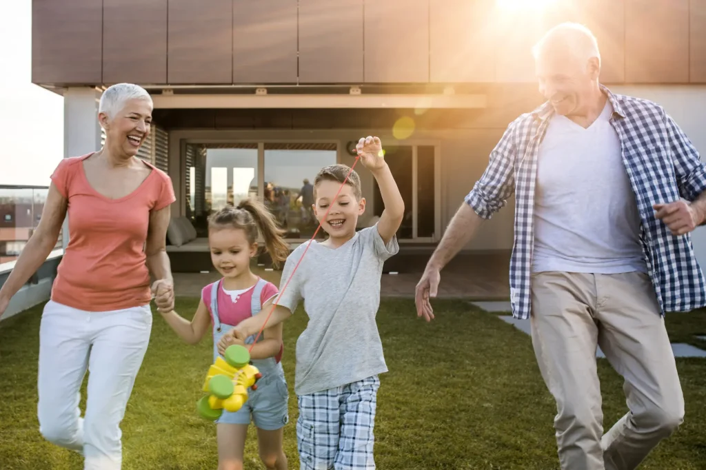 grandparents running outside and playing with grandkids