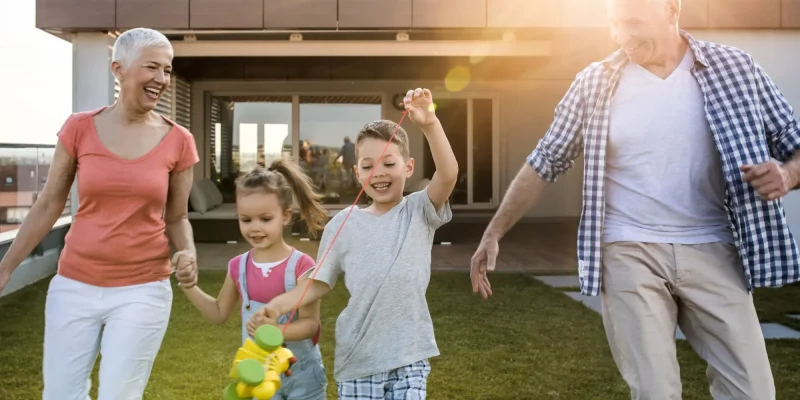 grandparents having fun outside with grandkids