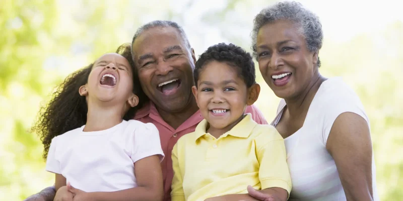 grandparents laughing with grandkids