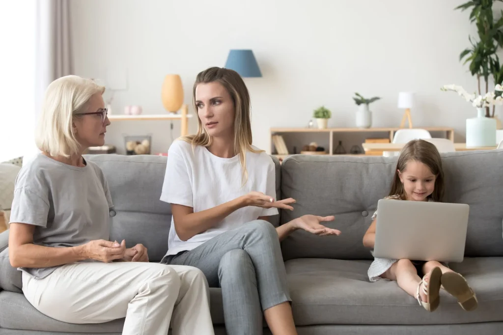 Mother and grandmother discussing little daughter