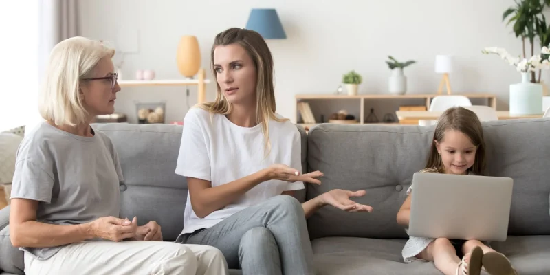 Mother and grandmother discussing little daughter