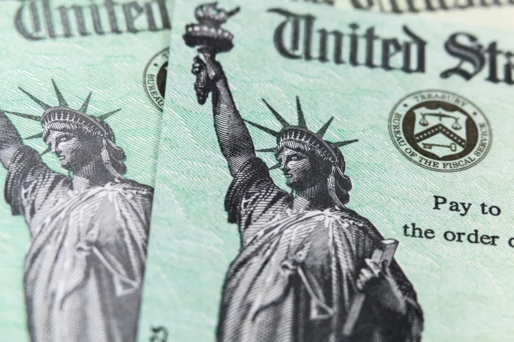 Macro view of the Statue of Liberty on two United States Treasury checks social security