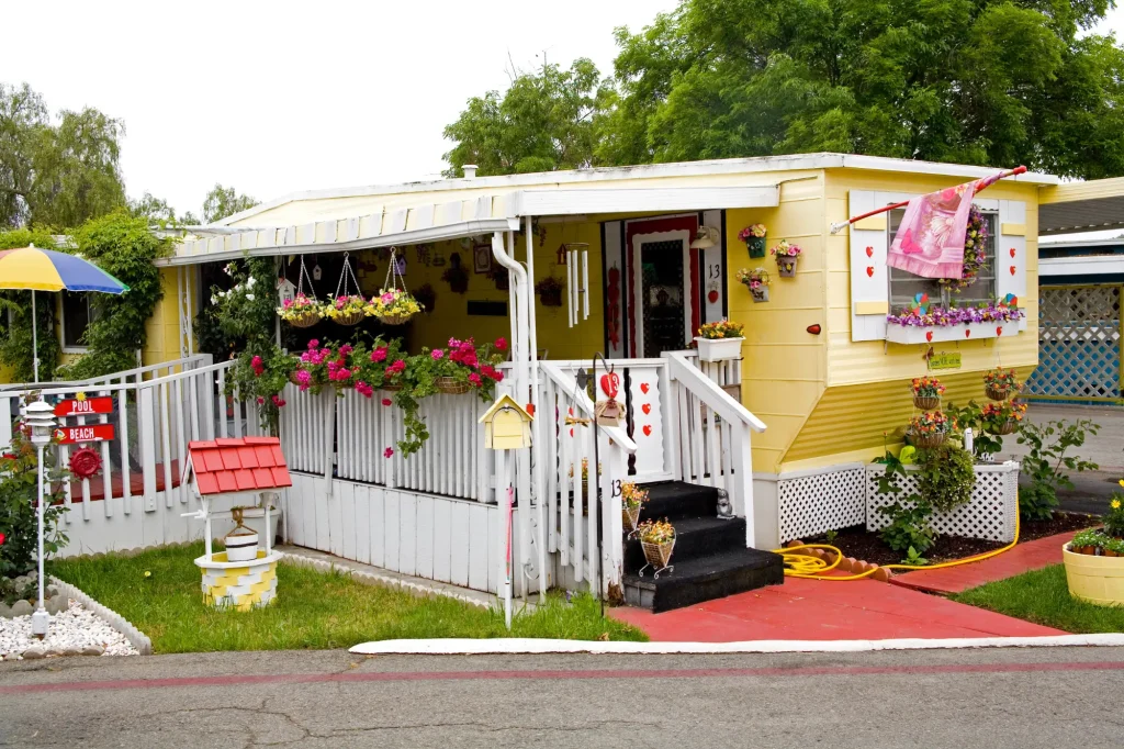 yellow mobile home with lots of flowers