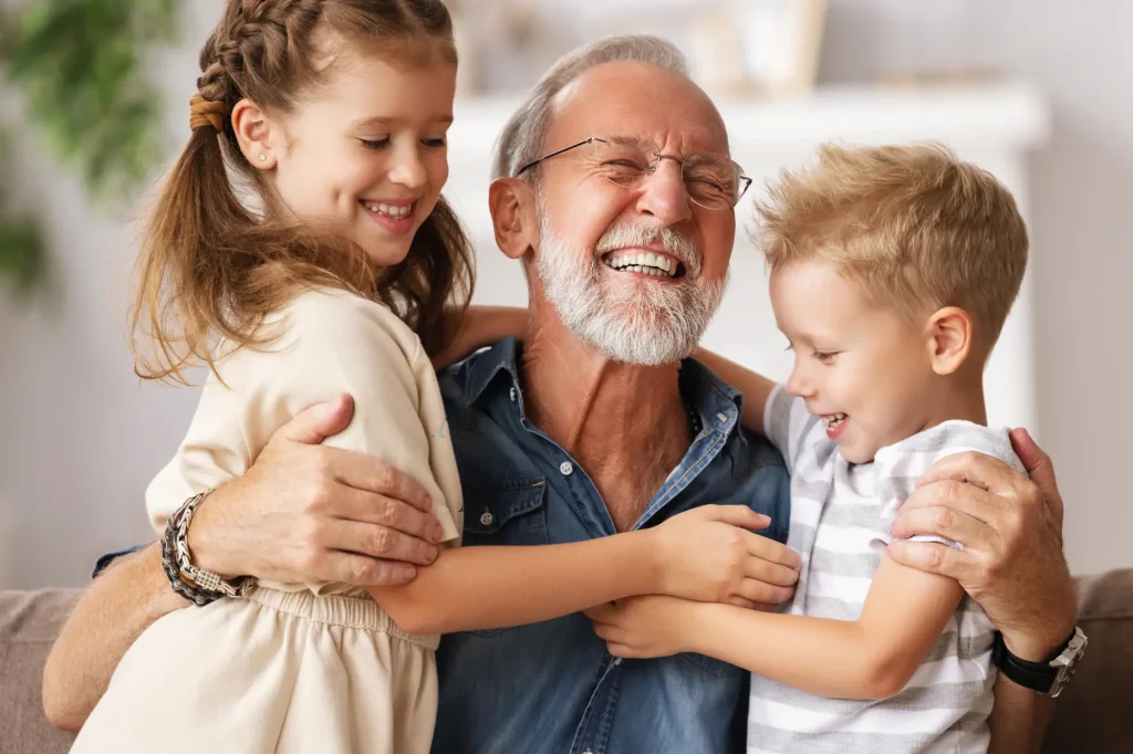grandpa with grandkids laughing together