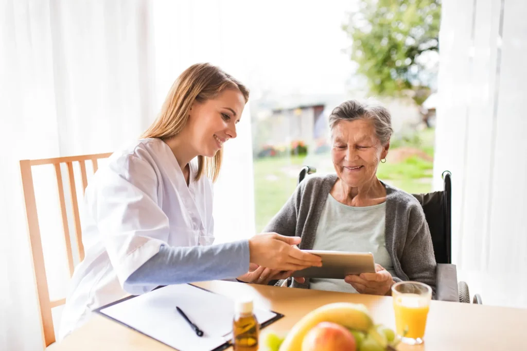 home health nurse with patient at her table