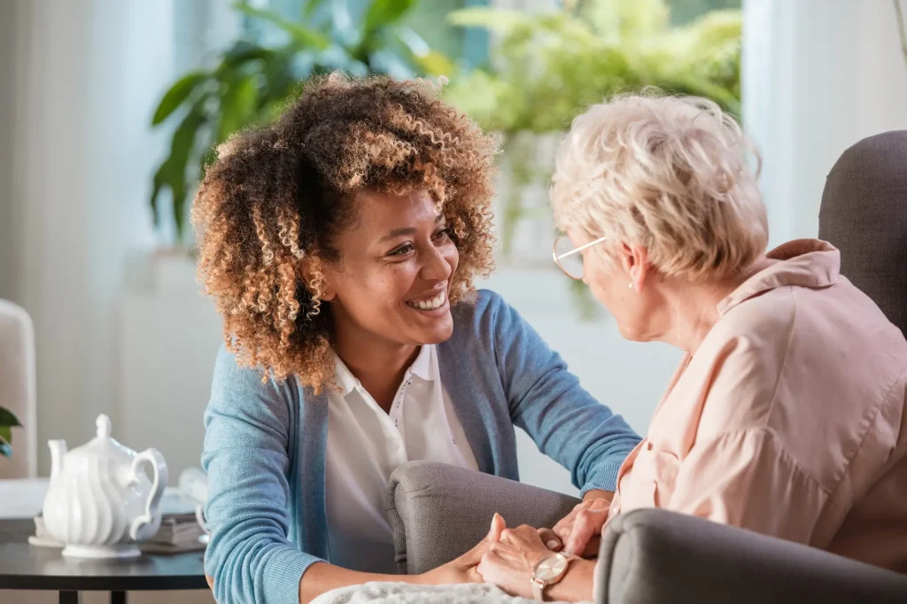 home health caregiver with patient in her home