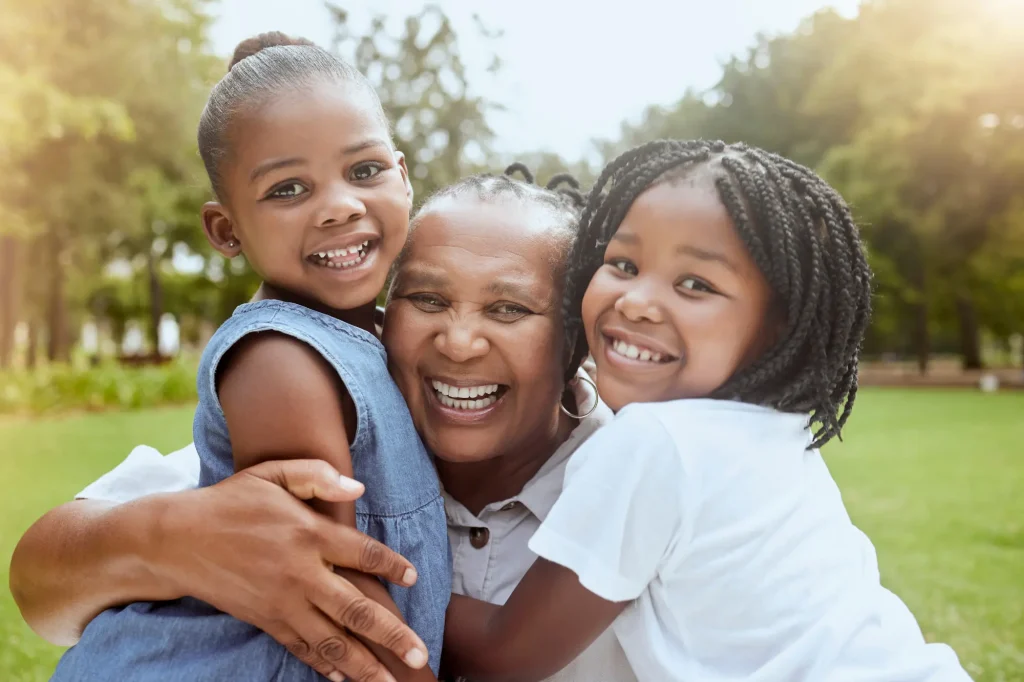 granmother and granddaughters close up and smiling