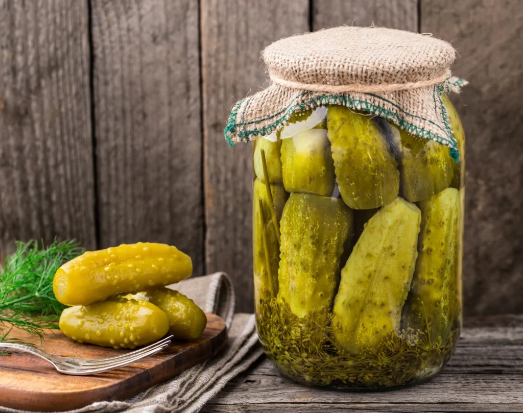 Jar or pickles sitting on a table