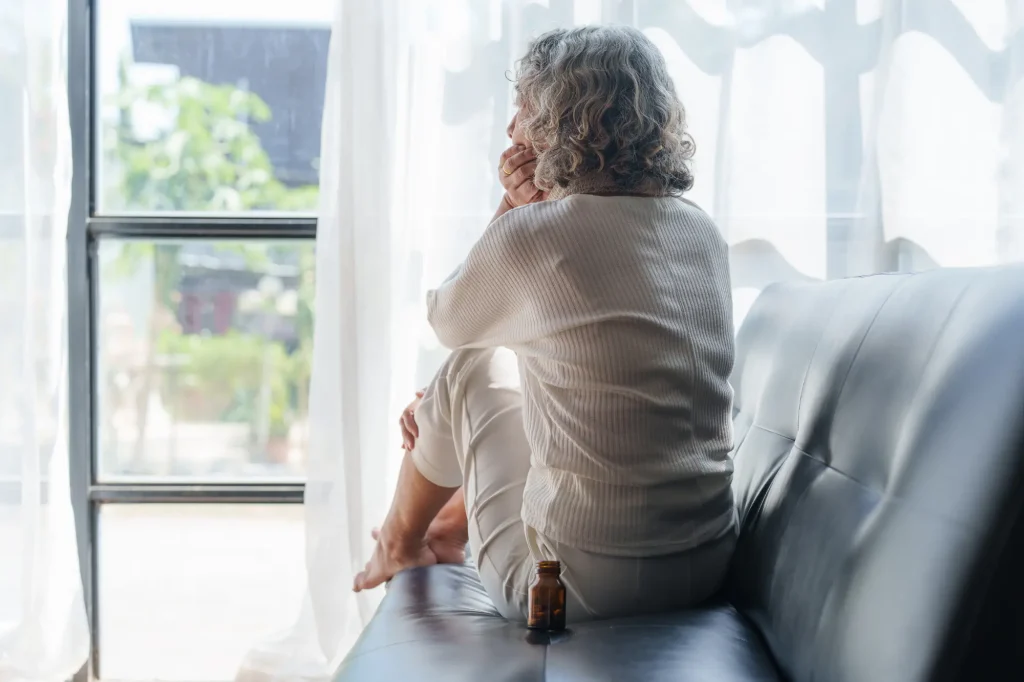 senior lady depressed staring out the window