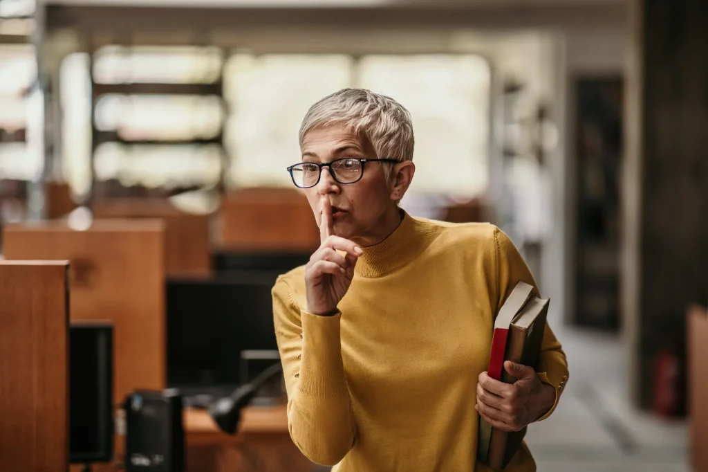 librarian shushing patrons