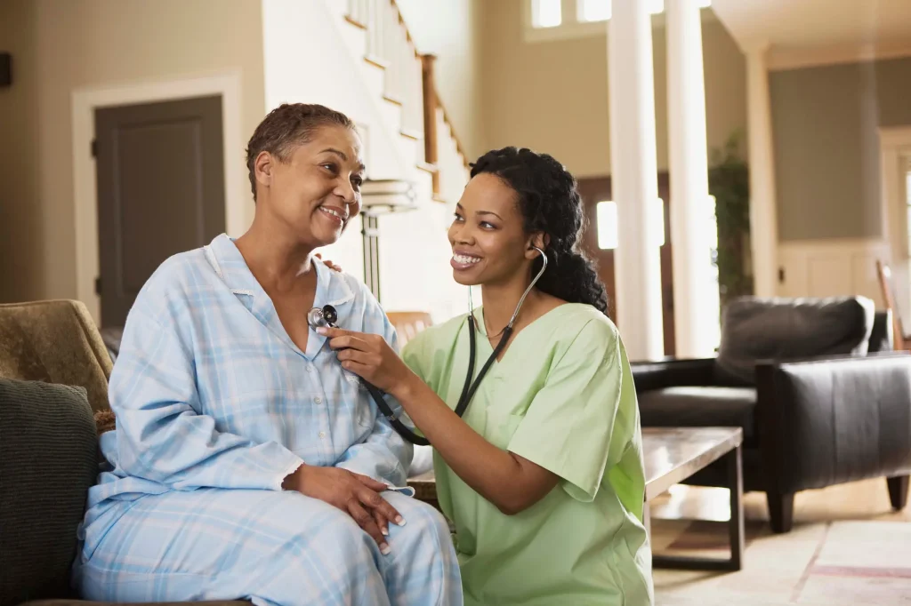 nurse in green scrubs helping a participant at adult daycare