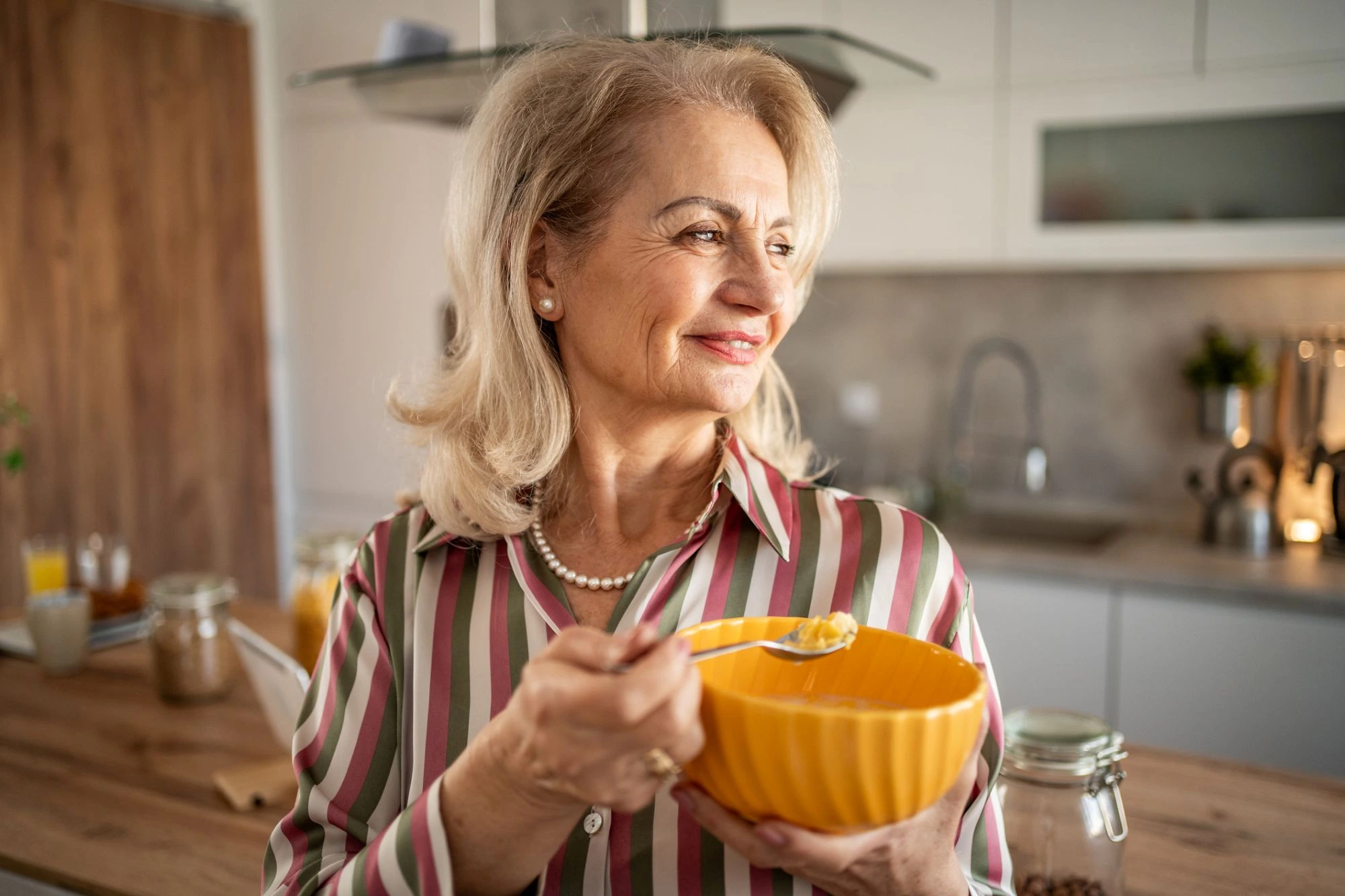 senior woman eating yogurt