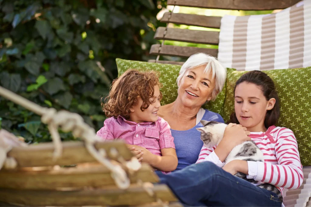 grandma with granddaughters and cat