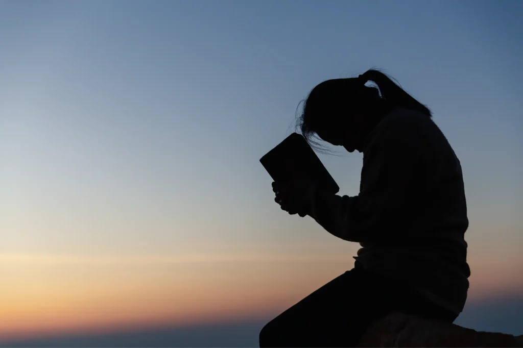 praying outside with a bible, silhouette