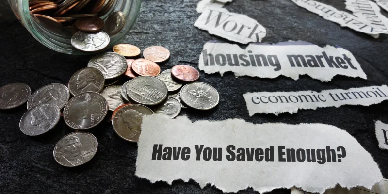 Have You Saved Enough news headline with coin jar and assorted economic newspaper headlines -- retirement concept