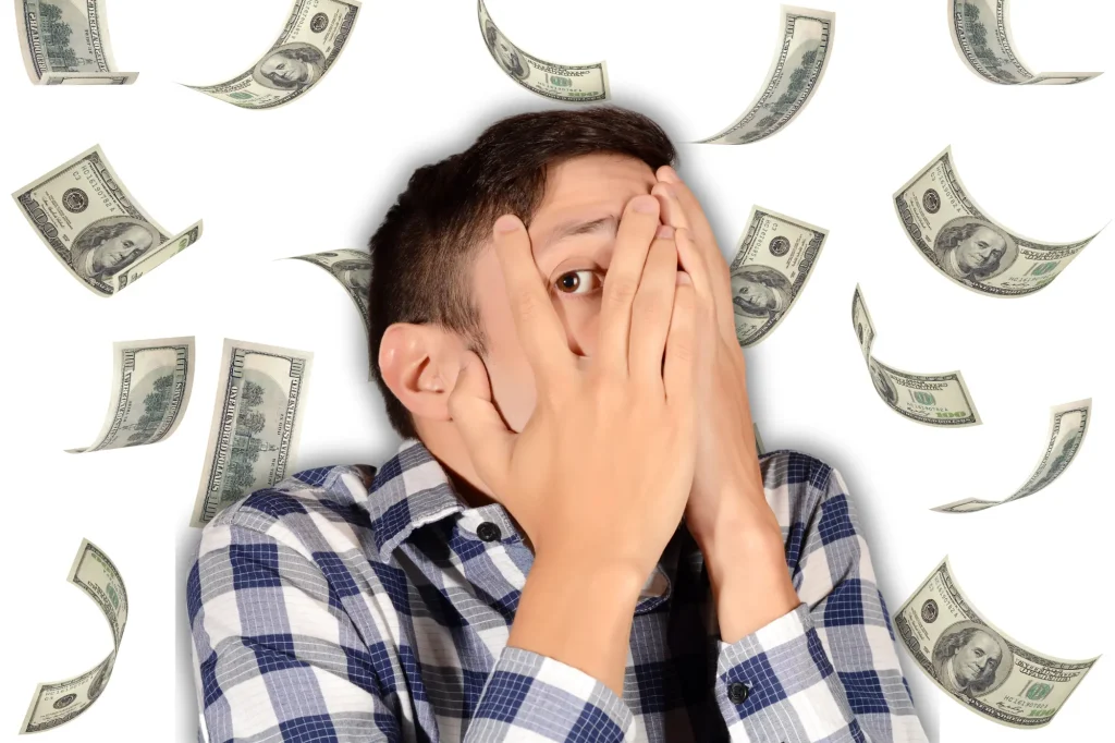 money falling man covering eyes