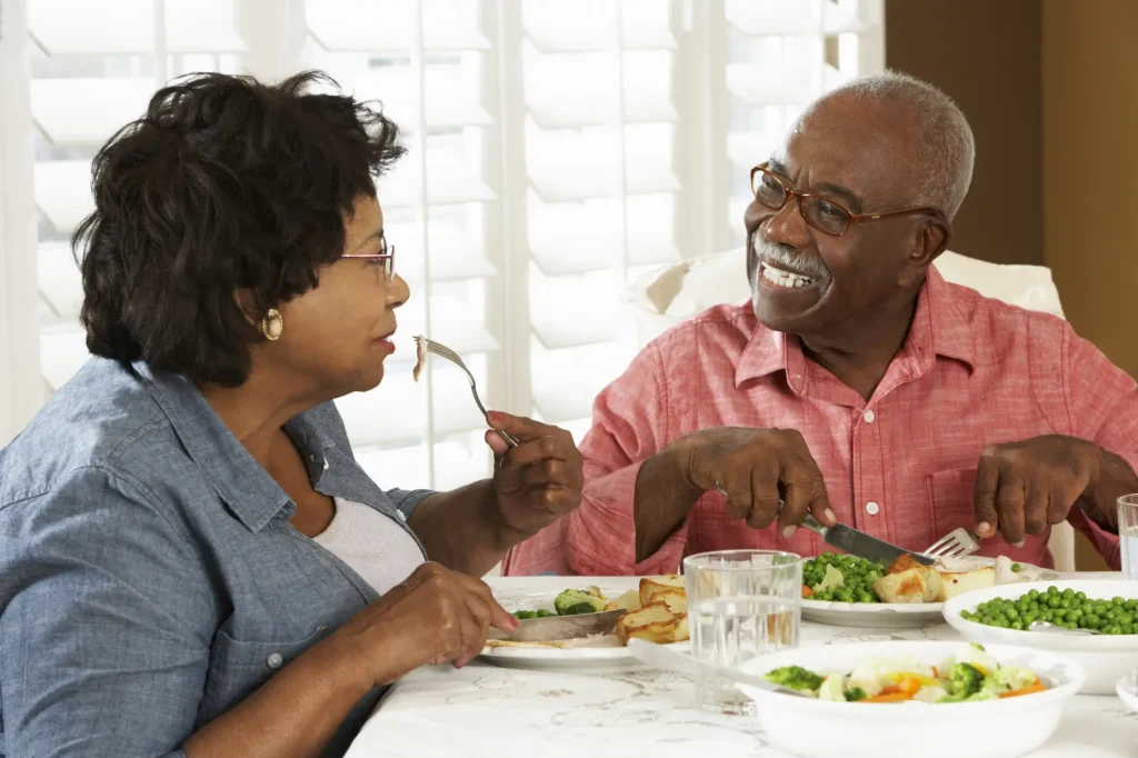 senior couple eating a meal at the table together
