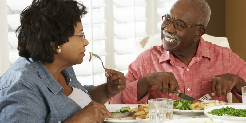 senior couple eating a meal at the table together
