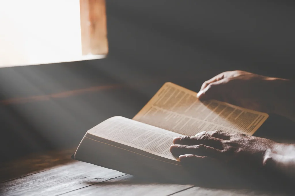 elderly hands on the bible