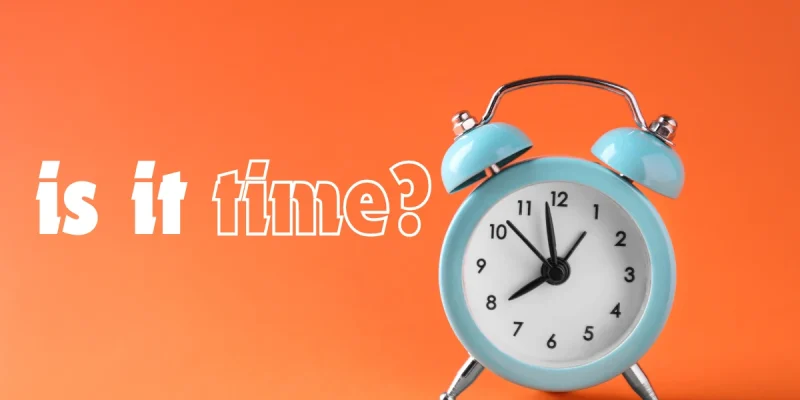 is it time? written in white on an orange background with an alarm clock next to words
