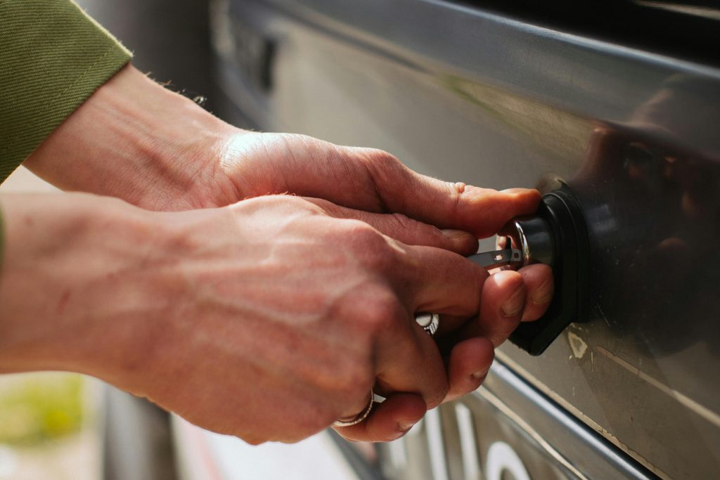 hands locking a car door
