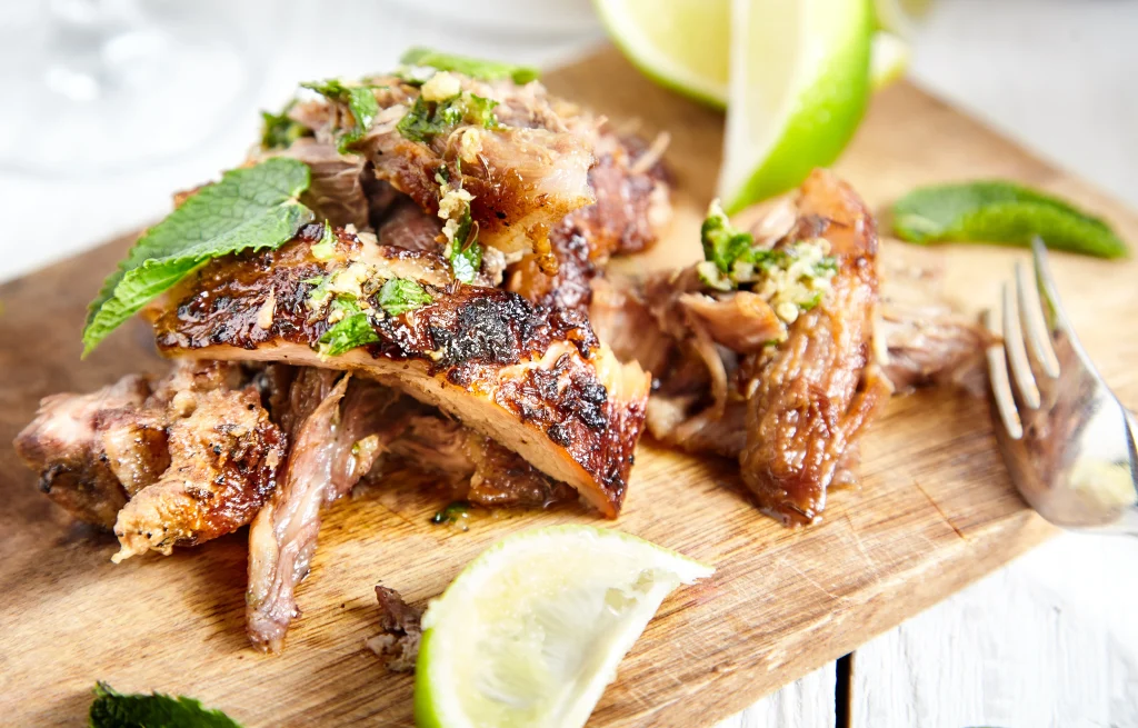 cuban pork roast with lime on a cutting board