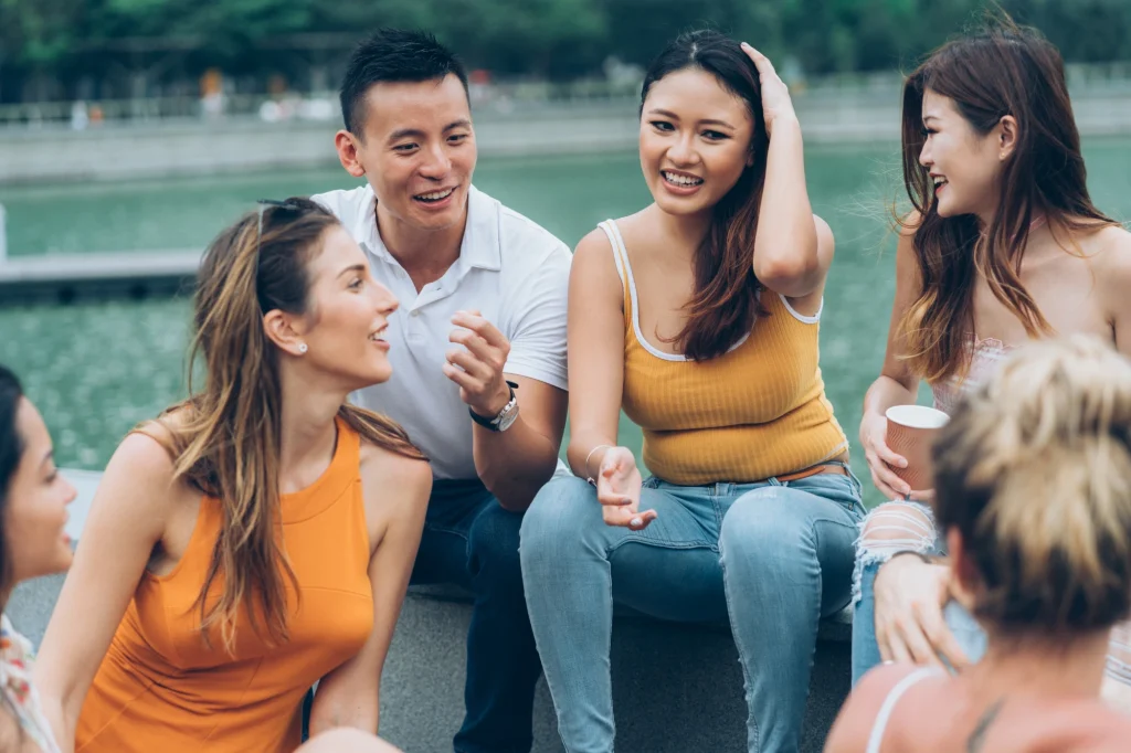 friends hanging out outside with coffee