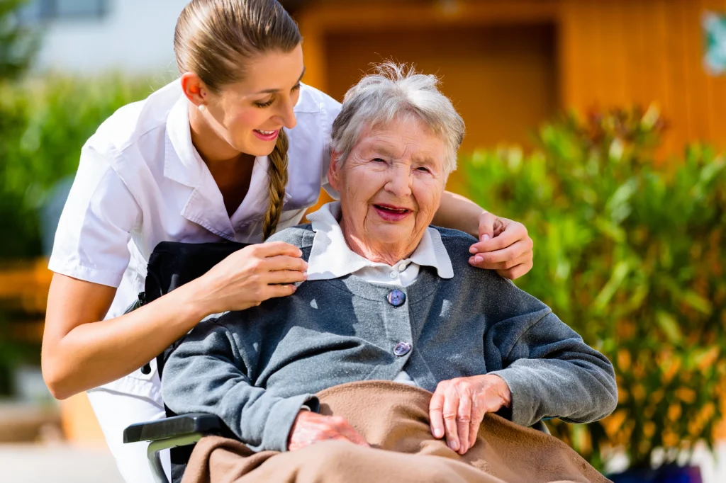 senior woman in a wheelchair and a caregiver