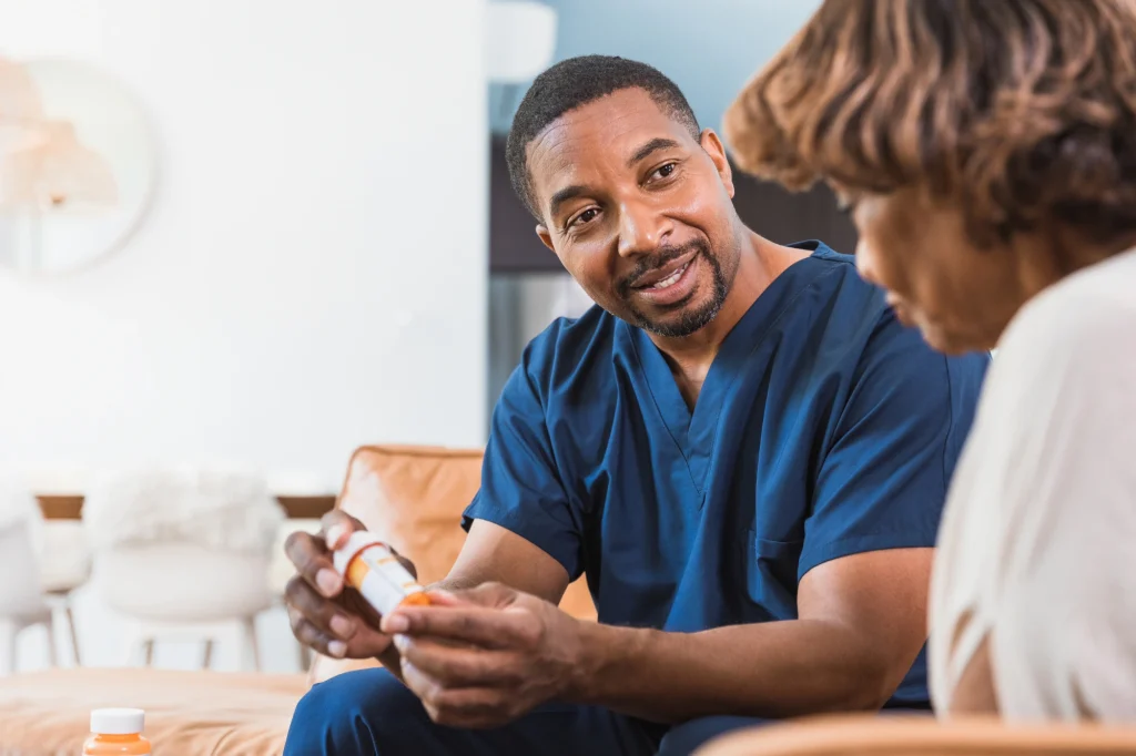 senior woman with a caregiver and medication