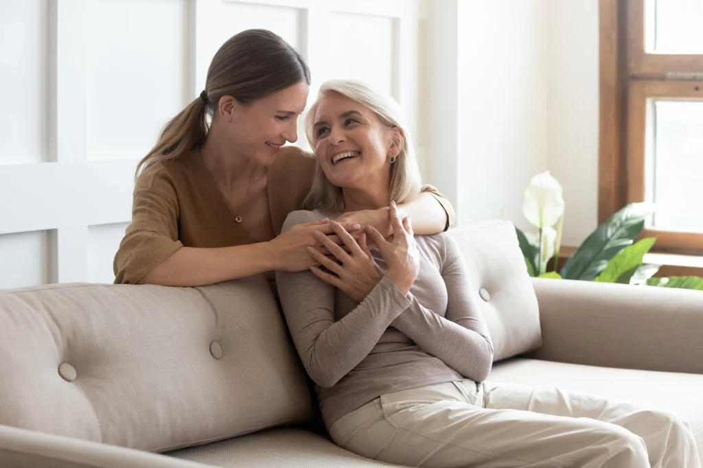 mom and daughter hug on couch