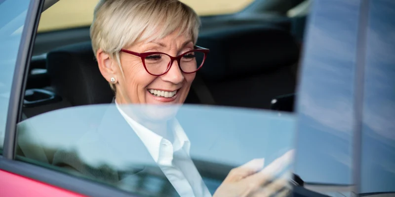 senior woman getting rideshare transportation